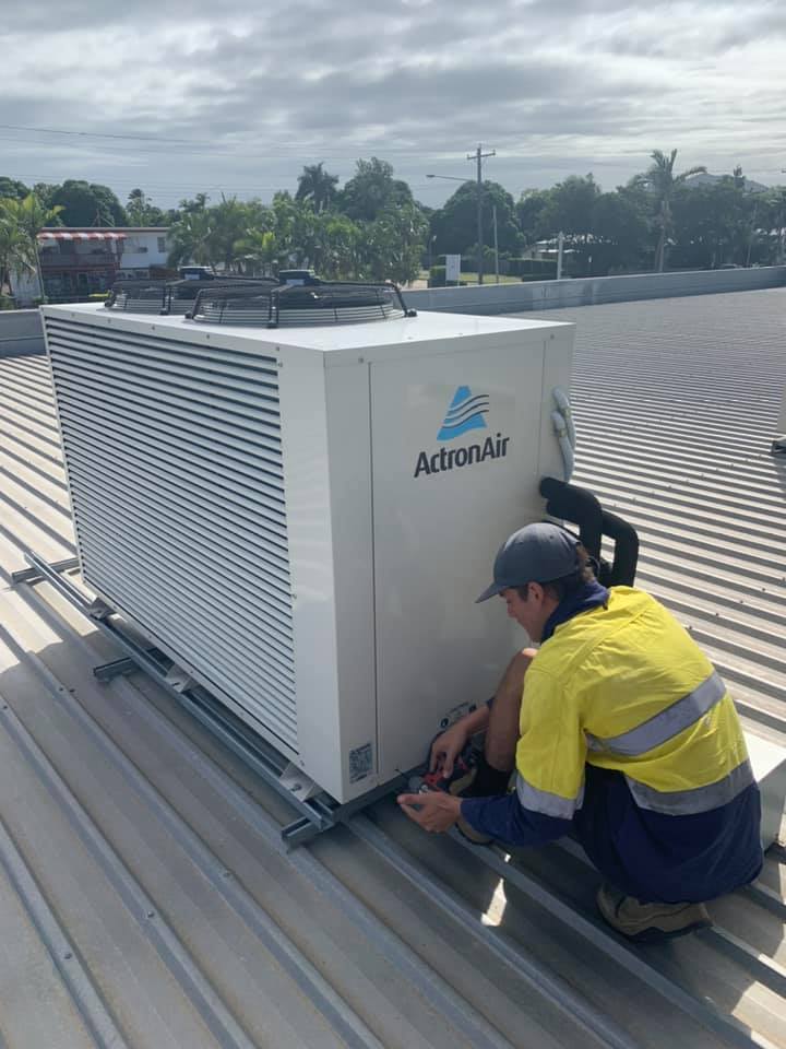 Townsville Refrigeration mechanic repairing a rooftop unit.